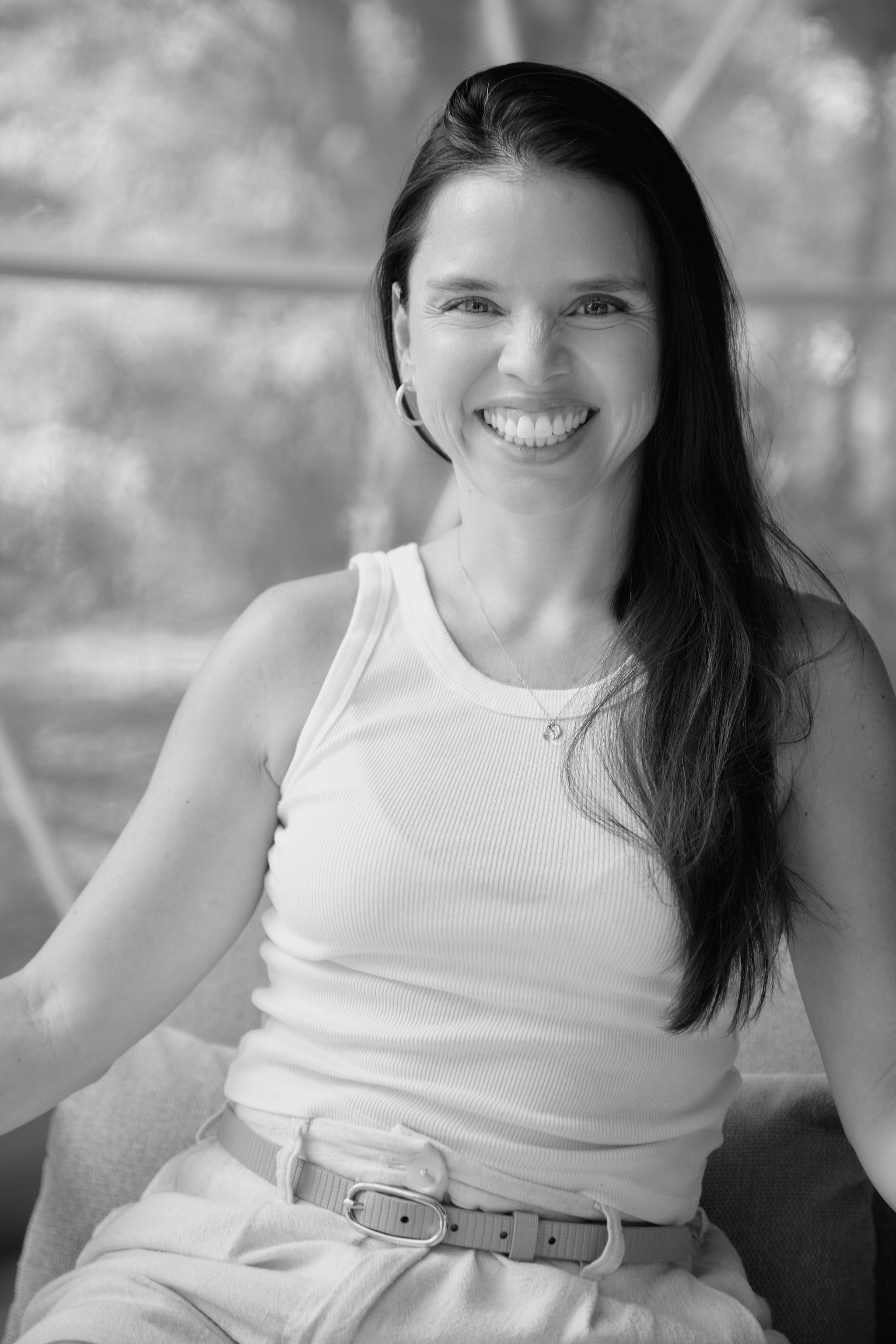 Paola Castro smiling in a black-and-white portrait